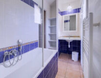 a kitchen with a blue tiled wall